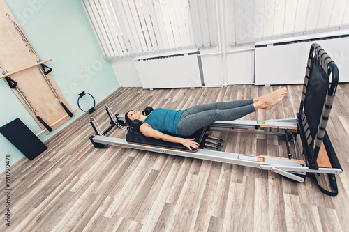 Woman exercising on pilates reformer