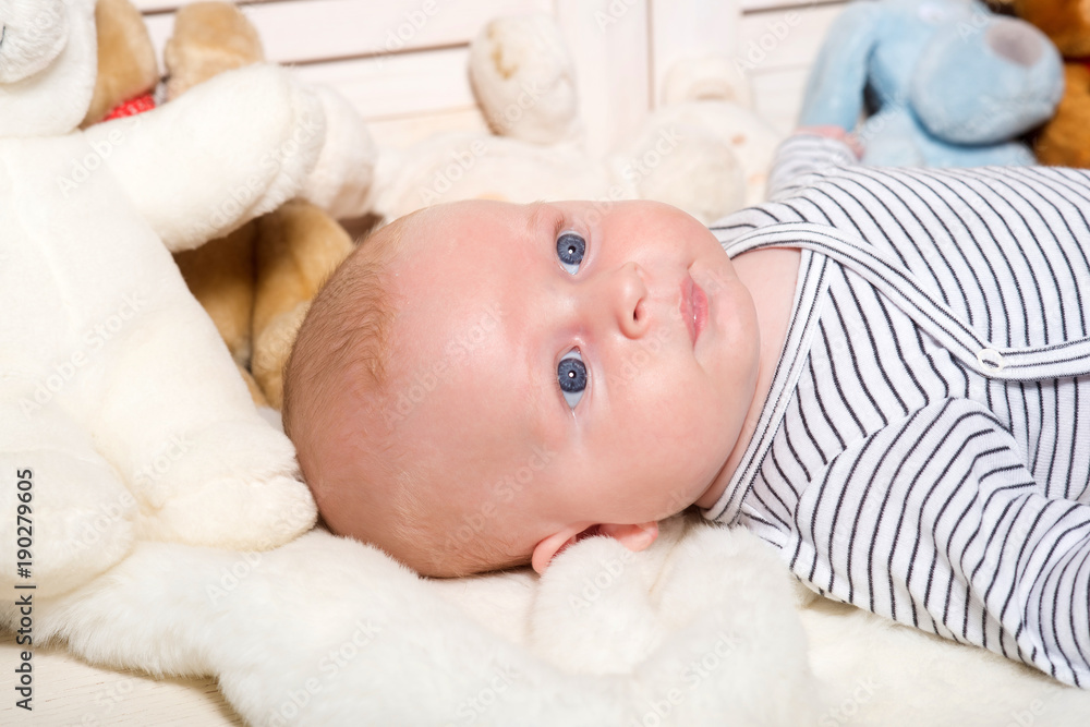 Childhood and curiosity concept. Baby boy in striped bodysuit. Childhood and curiosity concept. Baby boy in striped bodysuit.