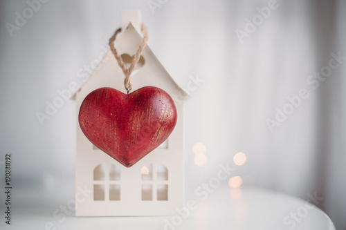 Home and red heart on white background.  concept for St. Valentine's Day and sale of houses