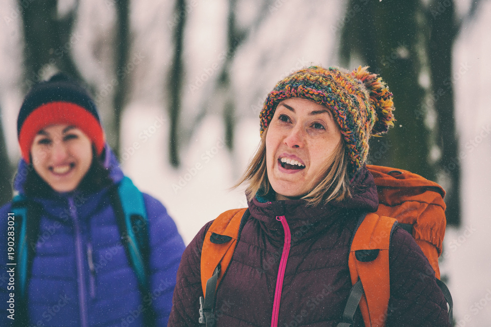 two girls go on a hike in winter