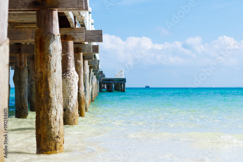 pier on tropical island with turquoise water, copy space