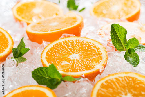 Segments of orange fruits and ice.