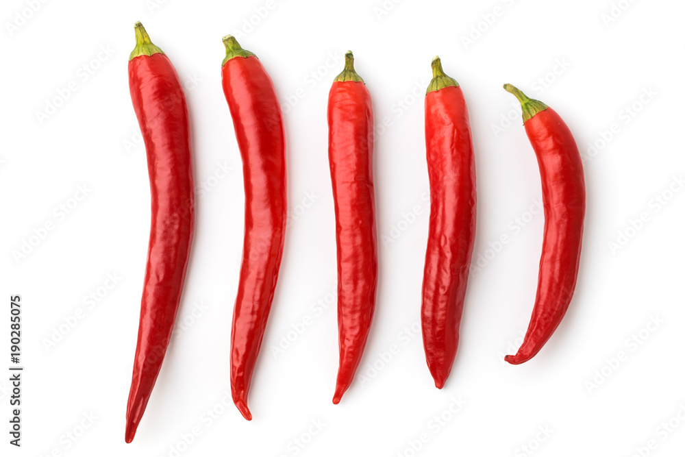 Five red chilli peppers on a white background, isolated.
