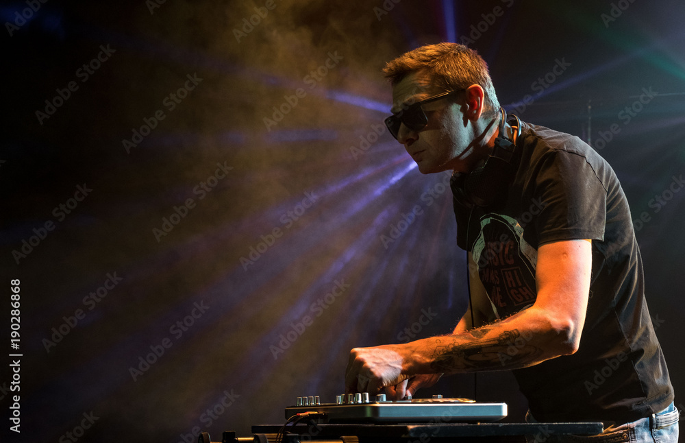DJ work in a nightclub. Disco light in the club. DJ behind the turntable. DJ work in a nightclub. Disco light in the club. DJ behind the turntable.