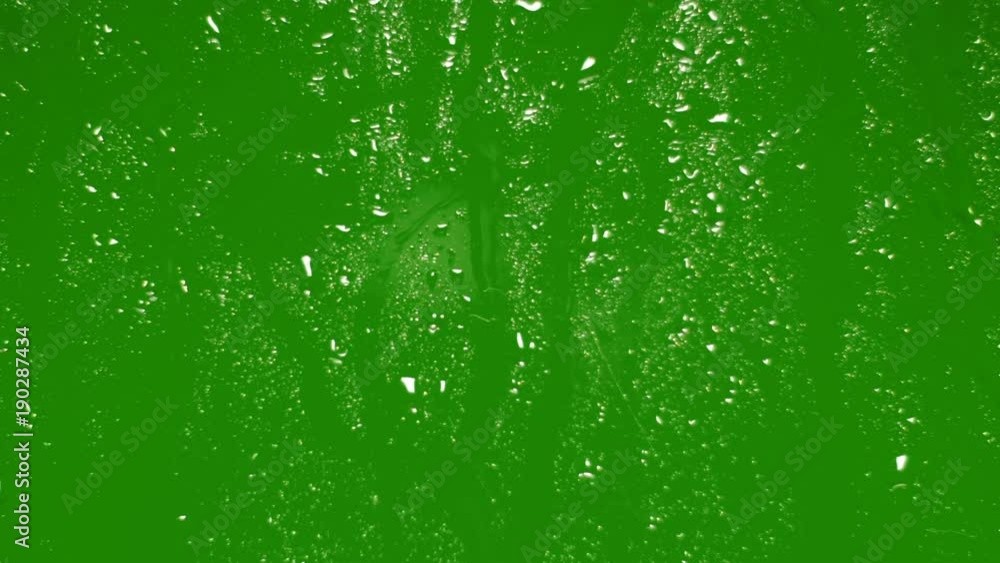 Rain drops on glass. Green screen backround. Chroma key.