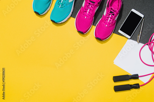Fitness accessories, healthy and active lifestyles concept background with copy space for text. Products with vibrant, punchy pastel colours and frame composition. Image taken from above, top view.