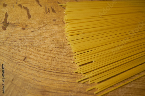 Yellow long spaghetti, Raw spaghetti on wooden background