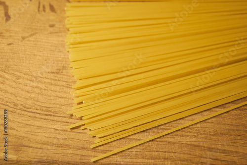Yellow long spaghetti, Raw spaghetti on wooden background
