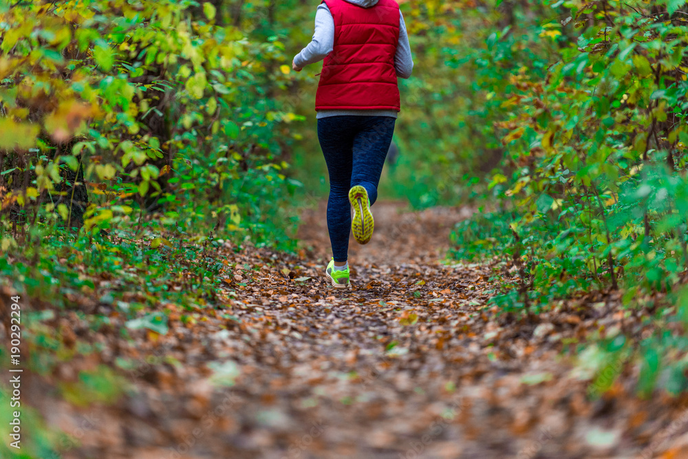 Woman running in the autumn park Woman running in the autumn park