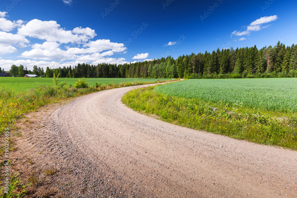 Turning rural road goes near green field Turning rural road goes near green field