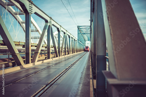 Passenger Train crossing bridge over river Danube