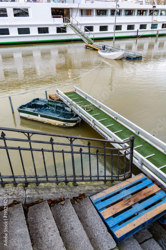 During a flooding episode, the only way to reach the boats mooring on the wharf of the Seine in Paris is to use a small boat from one gangway to another.