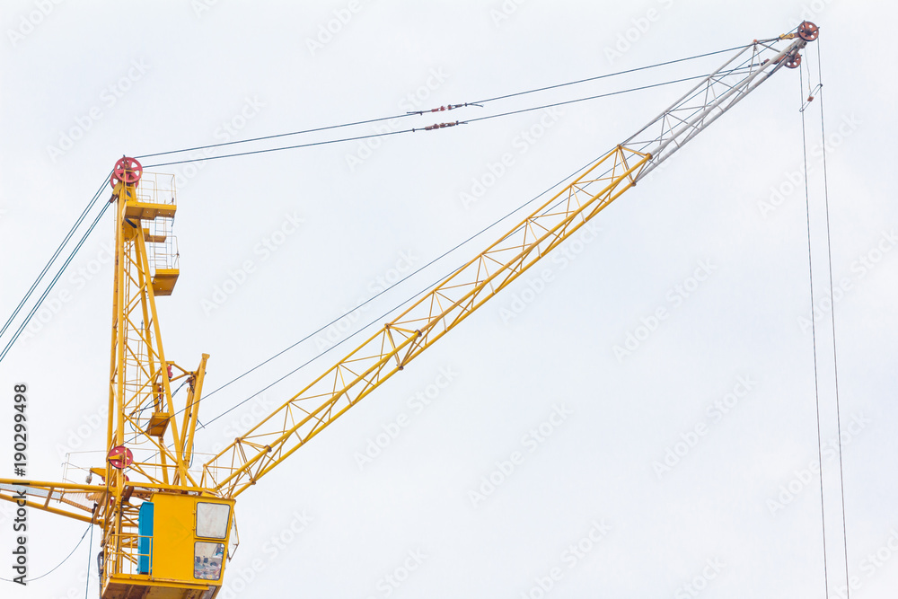 Building crane under construction against blue sky Building crane under construction against blue sky
