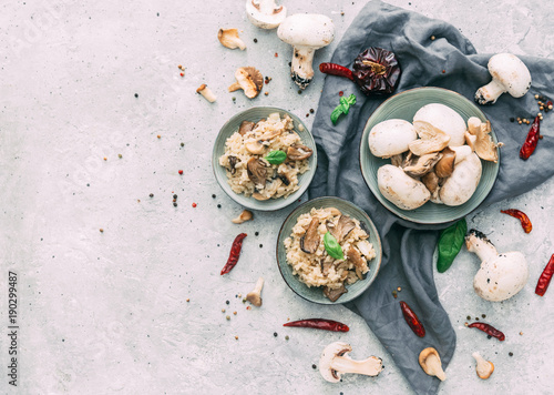 Risotto with porcini mushrooms on wooden background. Flat lay composition