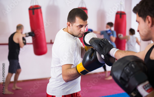 Sportsmen competing in boxing gloves © JackF