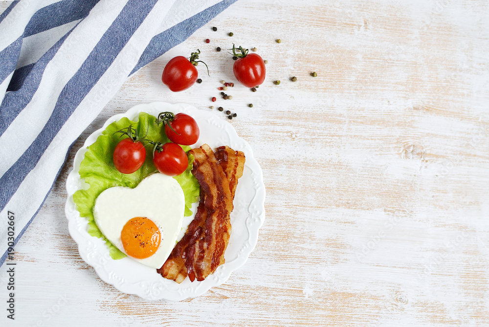 Tasty Fried Egg in the Shape of a Heart Served on a White Plate Bacon Pepper Tomato Salad Leaves Wooden Background Valentine Day Morning Tasty Fried Egg in the Shape of a Heart Served on a White Plate Bacon Pepper Tomato Salad Leaves Wooden Background Valentine Day Morning