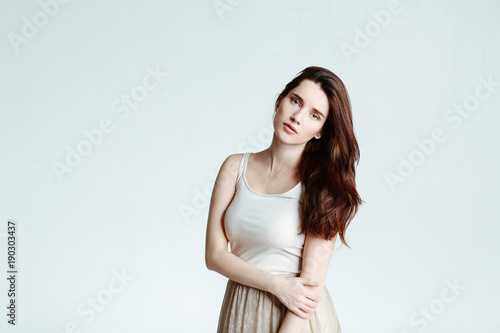 Portrait of the beautiful young woman of the brunette on a white background. Skin Care Concept, isolated on white.