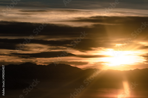 Φωτογραφία Utahs snow covered mountains from an airplane just as the sun starts to set