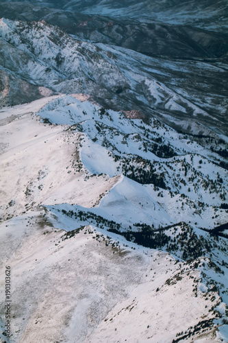 Utah's snow covered mountains from an airplane in the afternoon right after a snow storm cleared. 