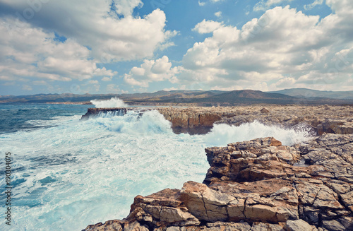 Big waves break about the Rocky Peninsula of Cape Lara in southern Akamas photo