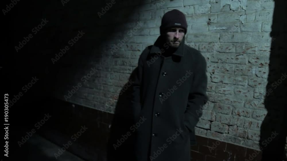 4k Lonely middle age man stands near brick wall later night at dark noir city 4k Lonely middle age man stands near brick wall later night at dark noir city