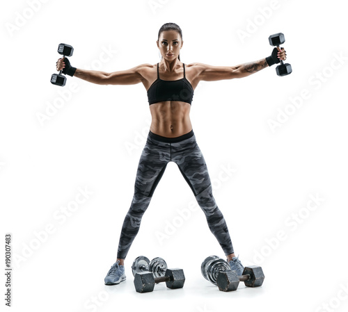 Fitness model exercising with dumbbells in both hands. Photo of muscular woman isolated on white background. Strength and motivation.