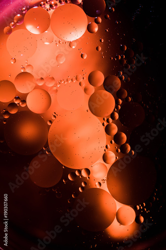 Abstract macro oil in water. I made this using a high powered falshlight and orange food coloring. That way there are hard shadows and bright circles to create a a unique look.