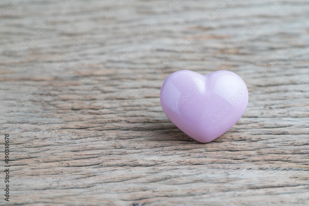 Valentines or wedding background with pink heart shape on wooden table with copy space, using as love wallpaper, minimal love greeting concept Valentines or wedding background with pink heart shape on wooden table with copy space, using as love wallpaper, minimal love greeting concept