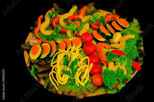 Zucchini  carrots  tomatoes and peppers on the tray.