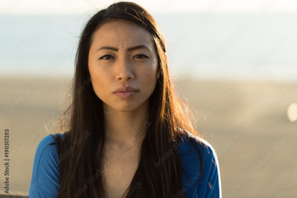 Young Asian woman serious face Stock Photo | Adobe Stock
