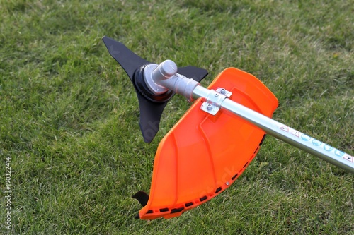 Brush cutter metal knife in green grass