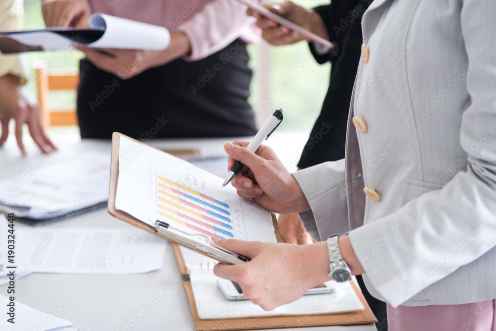 business woman and man discussing a new project using graph for data analysis , business team meenting concept business woman and man discussing a new project using graph for data analysis , business team meenting concept