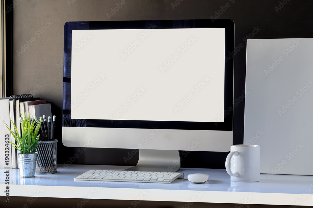 White workspace with mockup desktop computer and poster. White workspace with mockup desktop computer and poster.