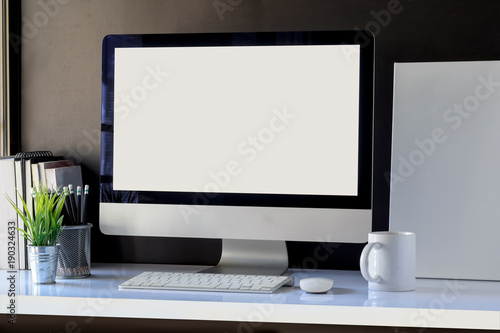 White workspace with mockup desktop computer and poster.