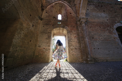 a girl in a ancient abandoned European building with backlight © mastersbaby0526
