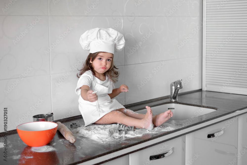 beautiful little girl learns to cook a meal in the kitchen beautiful little girl learns to cook a meal in the kitchen
