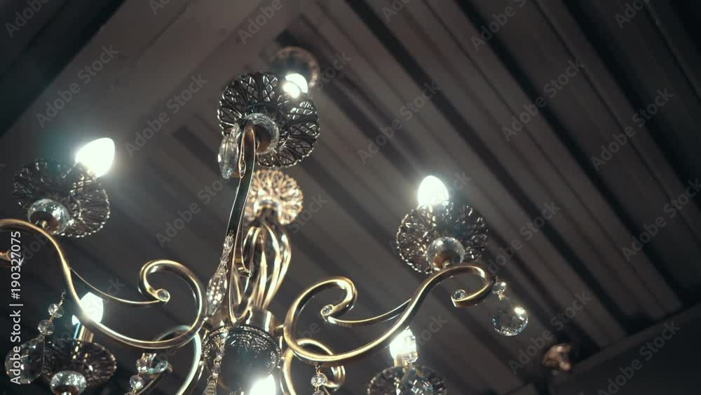 Luxury crystals of classical chandelier. Bottom view. Lamps are on. 4k video. Luxury crystals of classical chandelier. Bottom view. Lamps are on. 4k video.