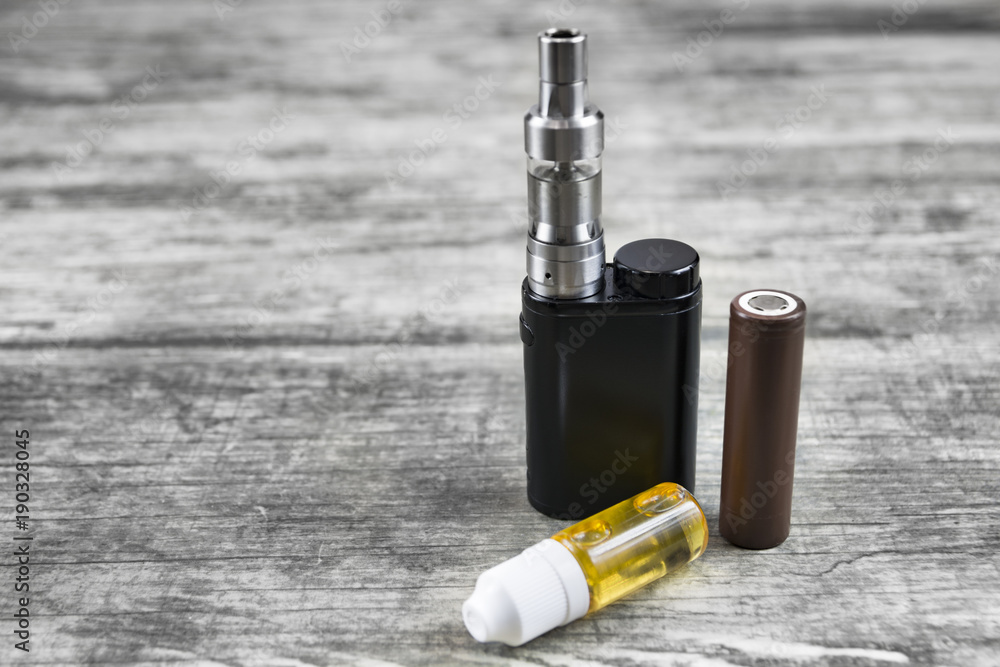 E - cigarette for vaping , technical devices.The liquid in the bottle E - cigarette for vaping , technical devices.The liquid in the bottle