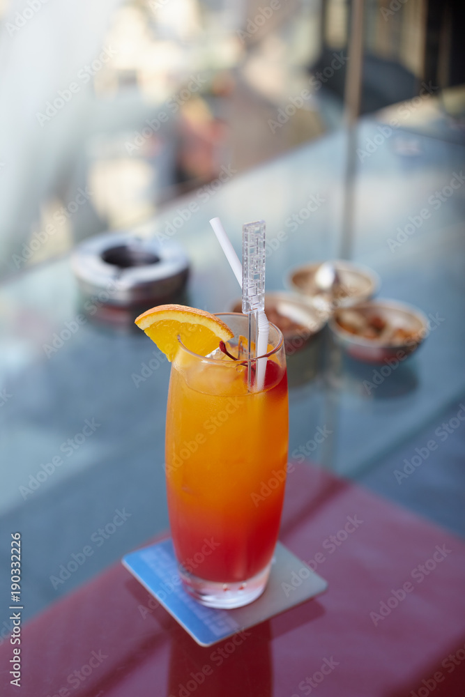 Fruits cocktail in the long glass on the glasses table Fruits cocktail in the long glass on the glasses table