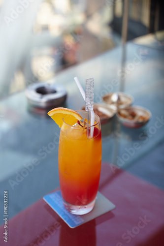 Fruits cocktail in the long glass on the glasses table