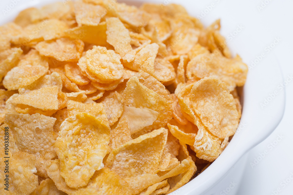 image Close up Cornflakes cereal breakfast in white bowl on white background. image Close up Cornflakes cereal breakfast in white bowl on white background.