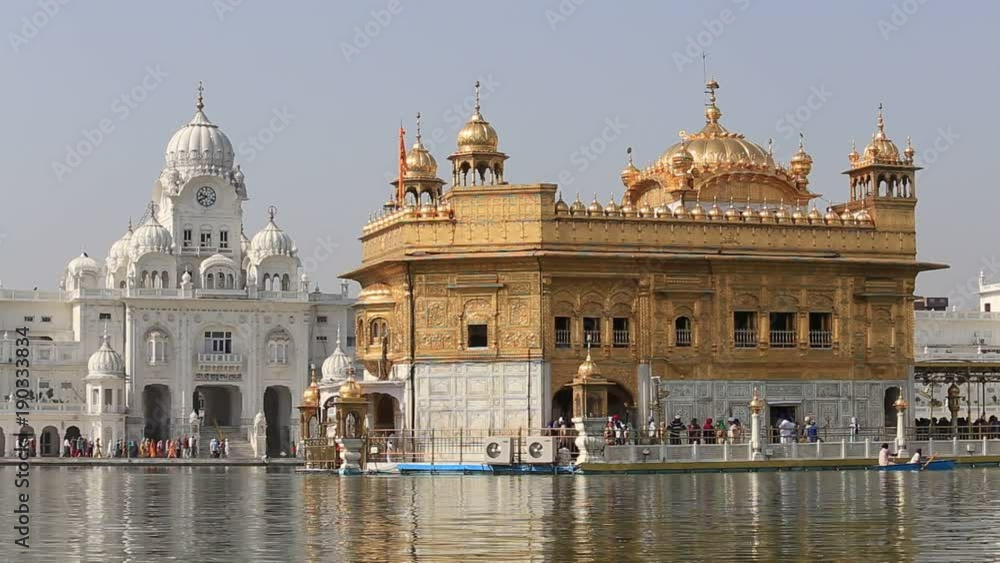 AMRITSAR, INDIA - SEPTEMBER 29, 2014: Unidentified Sikhs and indian people visiting the Golden Temple in Amritsar, Punjab, India. Sikh pilgrims travel from all over India to pray at this holy site. AMRITSAR, INDIA - SEPTEMBER 29, 2014: Unidentified Sikhs and indian people visiting the Golden Temple in Amritsar, Punjab, India. Sikh pilgrims travel from all over India to pray at this holy site.