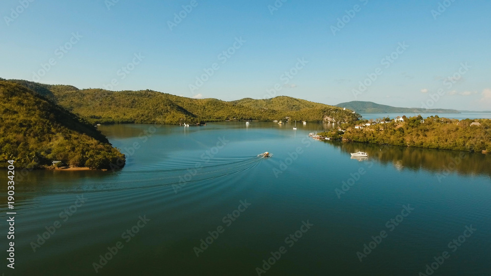 Seascape with a tropical bay surrounded by mountains on the island. Aerial view: Beautiful tropical sea bay. Scenic landscape with mountain islands and blue lagoon. Coron, Philippines,Palawan