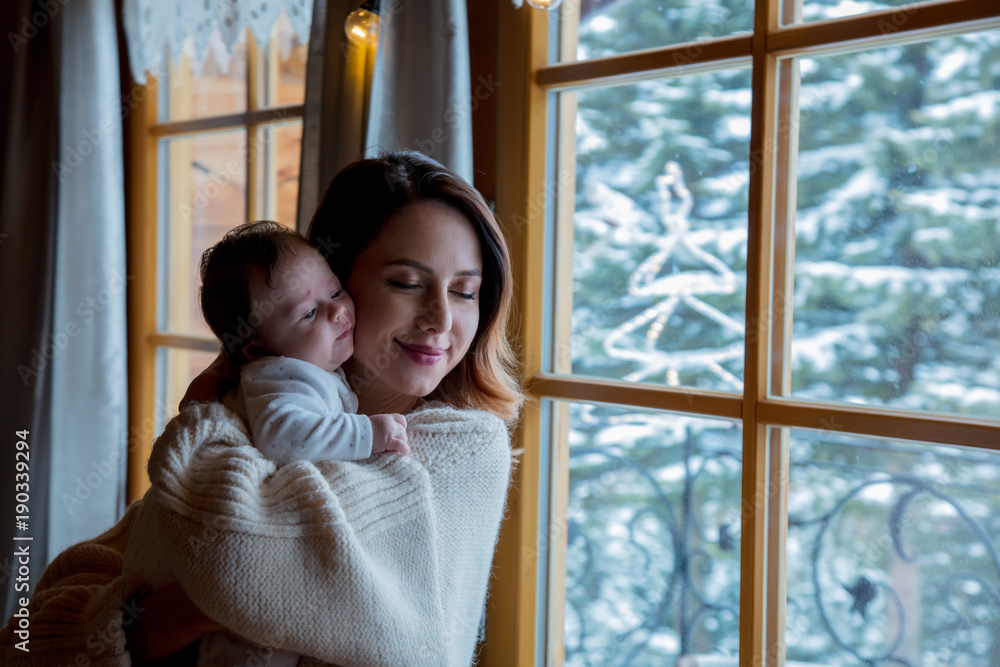 Young mother holding child indoor