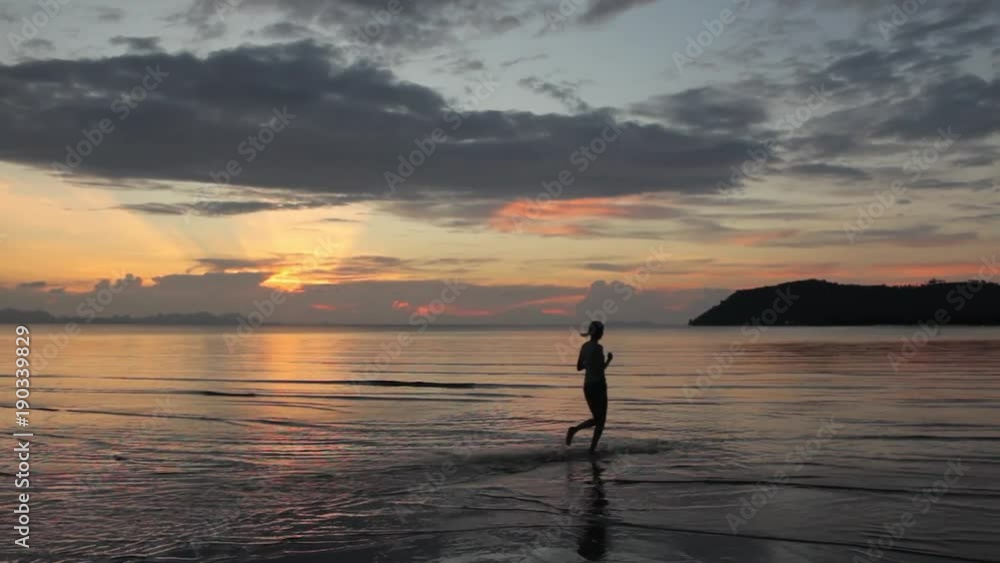 sports woman running on water at sunset in Thailand sports woman running on water at sunset in Thailand