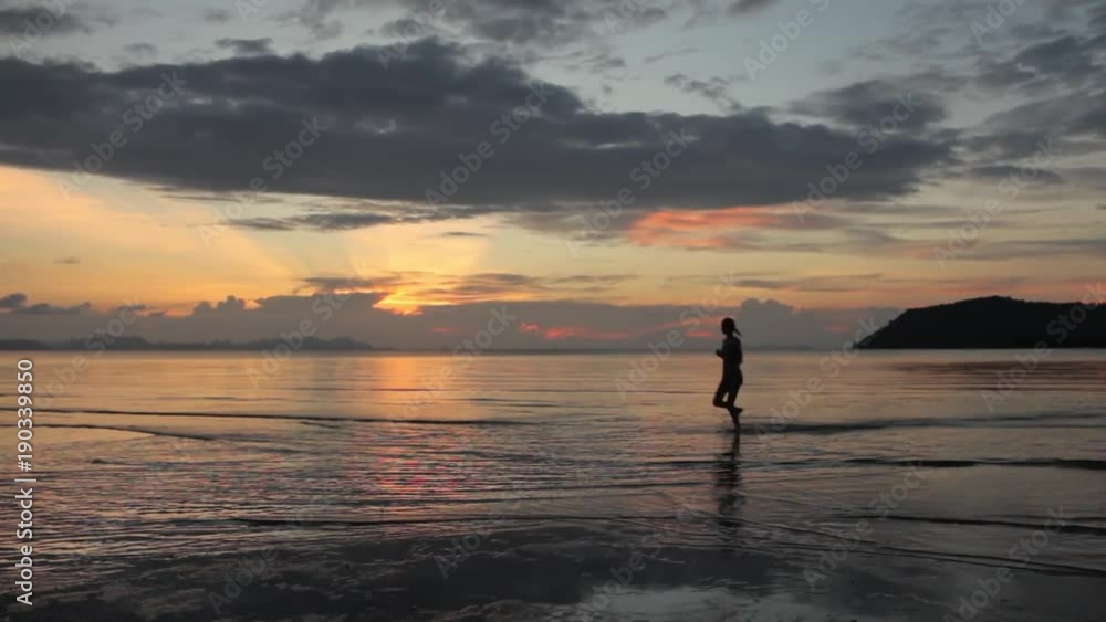 woman running on the beach at sunset woman running on the beach at sunset