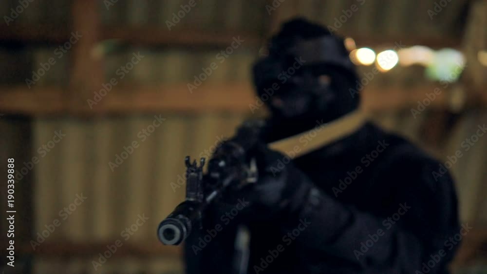 A black barrel of a modern rifle is pointed at camera. A black barrel of a modern rifle is pointed at camera.