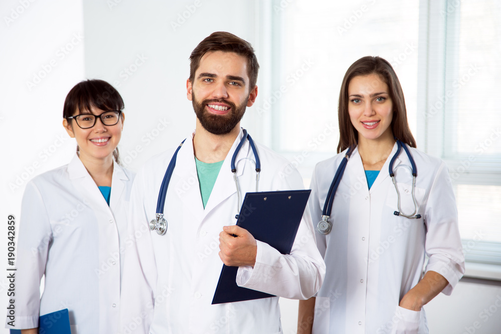 Group of doctors looking at camera and smiling Group of doctors looking at camera and smiling