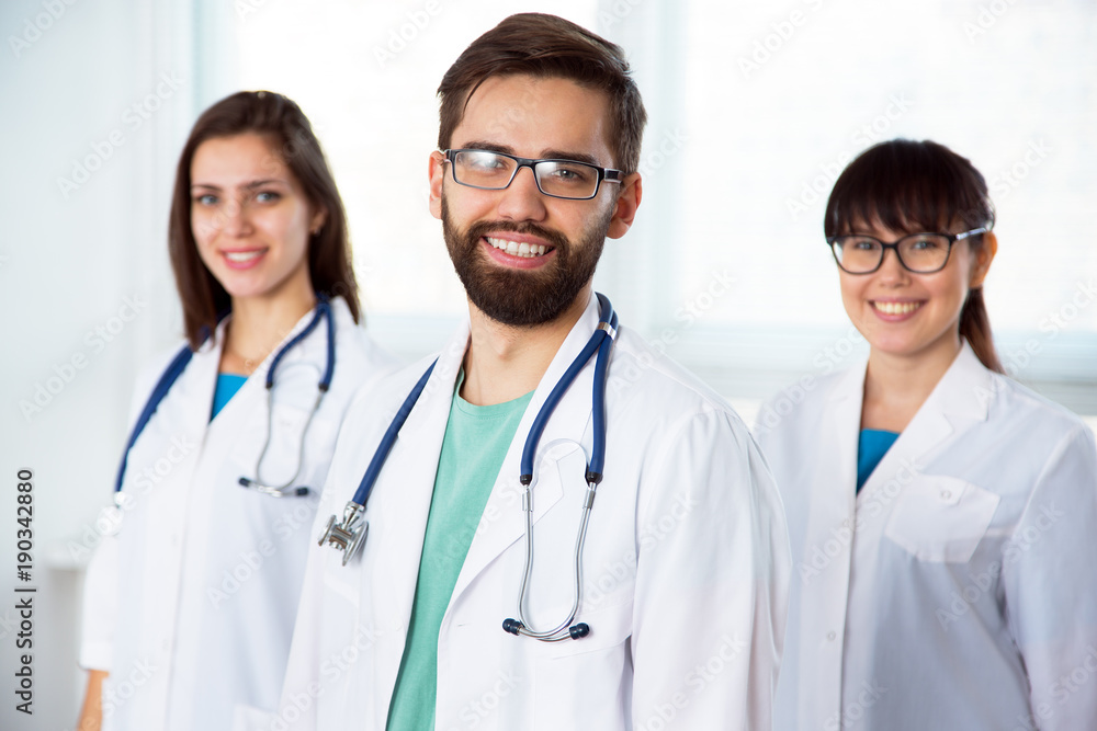 Group of doctors looking at camera and smiling Group of doctors looking at camera and smiling