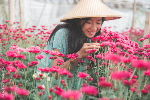 young asian woman working in chamomile flowers farm © Odua Images